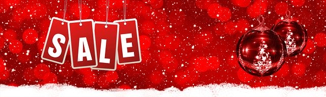 sign with word sale, red background and christmas ornaments