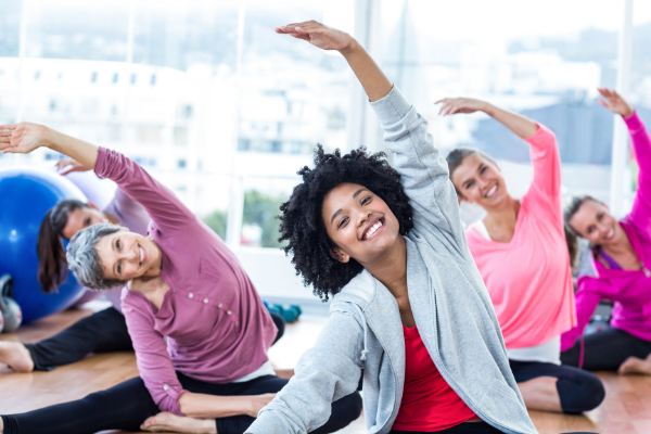 sitting women in exercise class smiling